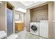 Bathroom featuring a walk in shower, vanity, mirror, and laundry area with washer and dryer at 6633 Old Ranch Rd, Sarasota, FL 34241