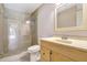 Bathroom featuring a glass enclosed shower, vanity, and beige tiling at 6633 Old Ranch Rd, Sarasota, FL 34241