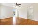 Bright bedroom with hardwood floors, fan, and access to a balcony and bathroom at 6633 Old Ranch Rd, Sarasota, FL 34241