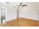 Bright bedroom with hardwood floors, ceiling fan, and access to the bathroom at 6633 Old Ranch Rd, Sarasota, FL 34241