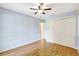 Bedroom features hardwood floors, large closet, and light blue painted walls at 6633 Old Ranch Rd, Sarasota, FL 34241