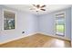 Bedroom with hardwood floors, light blue walls, and two large windows at 6633 Old Ranch Rd, Sarasota, FL 34241