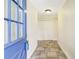 Inviting entryway with a blue front door and tile flooring leading into a bright hallway at 6633 Old Ranch Rd, Sarasota, FL 34241