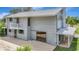 Exterior shot showcasing the side of a two-story home with attached structure and covered area, creating an inviting outdoor space at 6633 Old Ranch Rd, Sarasota, FL 34241