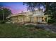 Unique home with a stone accent wall and covered porch, perfect for enjoying the outdoors at 6633 Old Ranch Rd, Sarasota, FL 34241
