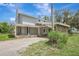 Well-lit home with a covered porch and distinctive stone accents on a spacious lot at 6633 Old Ranch Rd, Sarasota, FL 34241