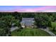 Charming two-story home featuring a stone foundation and inviting covered porch, surrounded by lush greenery at 6633 Old Ranch Rd, Sarasota, FL 34241