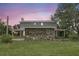 Two-story home with a stone exterior accent, featuring a covered porch on a well-maintained lawn at 6633 Old Ranch Rd, Sarasota, FL 34241