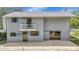 Two-story home exterior featuring a balcony, sliding glass doors, and a patio area for outdoor entertaining at 6633 Old Ranch Rd, Sarasota, FL 34241
