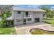 Rear exterior view of a home with a small balcony, attached structure, and partially visible in-ground pool at 6633 Old Ranch Rd, Sarasota, FL 34241