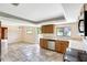 Bright kitchen with wooden cabinets, stainless steel dishwasher, and view to the back yard at 6633 Old Ranch Rd, Sarasota, FL 34241