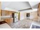 Kitchen area with tile floors, wood cabinets, stainless steel refrigerator, open to living area at 6633 Old Ranch Rd, Sarasota, FL 34241