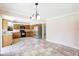 A kitchen area with wooden cabinets, stainless steel fridge, view to an open layout dining room at 6633 Old Ranch Rd, Sarasota, FL 34241