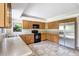 Bright kitchen featuring wooden cabinets, stainless steel refrigerator, and tile flooring at 6633 Old Ranch Rd, Sarasota, FL 34241
