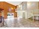 Open living room with staircase features a fireplace and sliding glass doors at 6633 Old Ranch Rd, Sarasota, FL 34241