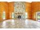 Spacious living room featuring a stone fireplace and wood paneled walls at 6633 Old Ranch Rd, Sarasota, FL 34241