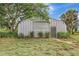 Metal outbuilding with roll-up door on a grassy lot, offering versatile storage or workspace at 6633 Old Ranch Rd, Sarasota, FL 34241