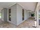 Covered porch featuring beautiful stone floors and views of the surrounding greenery at 6633 Old Ranch Rd, Sarasota, FL 34241