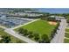 Expansive aerial view featuring a marina, recreational field, and residential area near the waterfront at 6707 Northampton Pl, Bradenton, FL 34207
