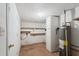 Utility space in basement with storage shelves and water heater at 6707 Northampton Pl, Bradenton, FL 34207