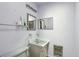 This bathroom has a sink and shelving, with lavender walls and white tile at 6707 Northampton Pl, Bradenton, FL 34207