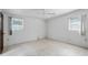 Bright bedroom with light colored walls and tile flooring, windows on two walls, and ceiling fan at 6707 Northampton Pl, Bradenton, FL 34207