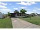 Charming single-story home with well-manicured lawn and mature landscaping, complemented by a lengthy private driveway at 6707 Northampton Pl, Bradenton, FL 34207