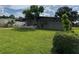 Lush green lawn surrounds a charming single-story home with a carport on a sunny day at 6707 Northampton Pl, Bradenton, FL 34207