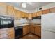 Cozy kitchen featuring wood cabinets, tiled backsplash, and appliances at 6707 Northampton Pl, Bradenton, FL 34207