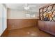 Retro living room featuring vintage paneled walls, unique flooring, and a decorative room divider with natural lighting at 6707 Northampton Pl, Bradenton, FL 34207
