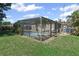 Relaxing enclosed backyard pool with secure screened enclosure, offering a private oasis surrounded by lush greenery at 6707 Northampton Pl, Bradenton, FL 34207
