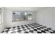 Sunroom with black and white tile floors and windows offering exterior views at 6707 Northampton Pl, Bradenton, FL 34207