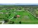 Aerial view of a sprawling estate with lush greenery, ponds, and a beautiful home and barn at 6805 225Th E St, Bradenton, FL 34211
