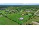 Beautiful aerial view of acreage featuring a home, barn, and serene pond, ideal for outdoor recreation at 6805 225Th E St, Bradenton, FL 34211