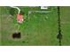 Aerial view of a home with a red roof, surrounded by a well-maintained lawn and a serene pond at 6805 225Th E St, Bradenton, FL 34211