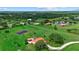 Aerial view of a red roof home, outdoor gazebo, mature trees, and landscaped grounds at 6805 225Th E St, Bradenton, FL 34211