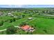 Aerial shot showcasing a large pasture, pond and a modern metal building on the property at 6805 225Th E St, Bradenton, FL 34211