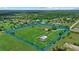 Aerial view of sprawling property with main house and barn outlined in blue at 6805 225Th E St, Bradenton, FL 34211