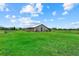 Spacious barn with ample green space is ideal for equestrian activities or livestock at 6805 225Th E St, Bradenton, FL 34211