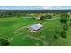 Aerial view of a fenced barn with metal roof on a sprawling green property and fenced pasture at 6805 225Th E St, Bradenton, FL 34211