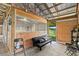 Resting space inside the barn featuring a black futon and chairs at 6805 225Th E St, Bradenton, FL 34211
