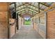 Inside of the barn featuring wood framed stalls with metal bars at 6805 225Th E St, Bradenton, FL 34211
