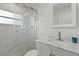 Bright bathroom featuring marble topped vanity and glass enclosed shower with marble tiling and modern fixtures at 6805 225Th E St, Bradenton, FL 34211