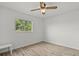 This bedroom has natural light and a ceiling fan over hardwood floors at 6805 225Th E St, Bradenton, FL 34211