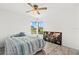 Bright bedroom with hardwood floors, ceiling fan, corner windows, and natural light at 6805 225Th E St, Bradenton, FL 34211