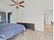 Simple bedroom with light wood floors and a blue accent wall through the double door entryway at 6805 225Th E St, Bradenton, FL 34211