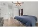 Cozy bedroom with ceiling fan, light wood flooring and an ensuite bathroom at 6805 225Th E St, Bradenton, FL 34211