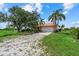 Expansive lawn and landscaping surround a one-story home with a red roof and two car garage at 6805 225Th E St, Bradenton, FL 34211