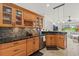 Kitchen with custom wood cabinets, granite countertops, and a stainless steel dishwasher at 6805 225Th E St, Bradenton, FL 34211