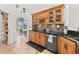 Kitchen with wood cabinets, granite countertops, and tile backsplash at 6805 225Th E St, Bradenton, FL 34211